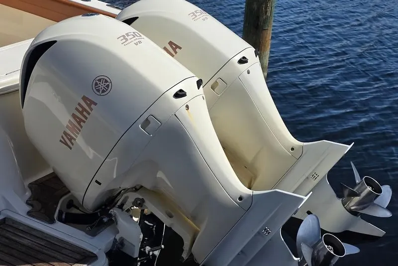 Slide: The Image of Twin Yamaha outboard engines on a 2015 Scout 350 LXF boat, docked by the water. - 17