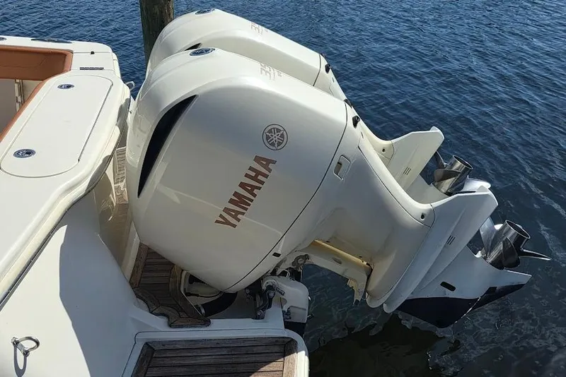 Slide: The Image of 2015 Scout 350 LXF boat with twin Yamaha outboard engines on water. - 18