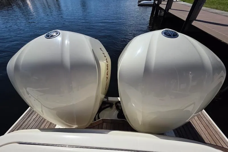 Slide: The Image of Twin Yamaha outboard engines on a 2015 Scout 350 LXF boat, docked by the water. - 19