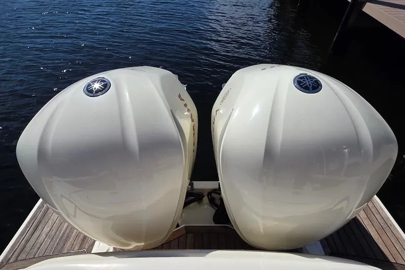 Slide: The Image of Twin Yamaha outboard engines on a 2015 Scout 350 LXF boat, docked by the water. - 20