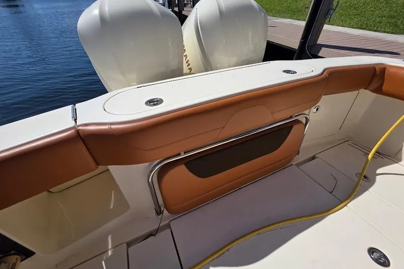 Slide: The Image of 2015 Scout 350 LXF boat interior with tan seating and dual Yamaha engines. - 26