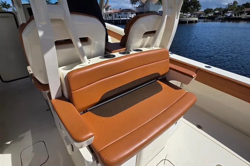 Slide: The Image of Luxury seating on 2015 Scout 350 LXF boat, docked by waterfront homes. - 28