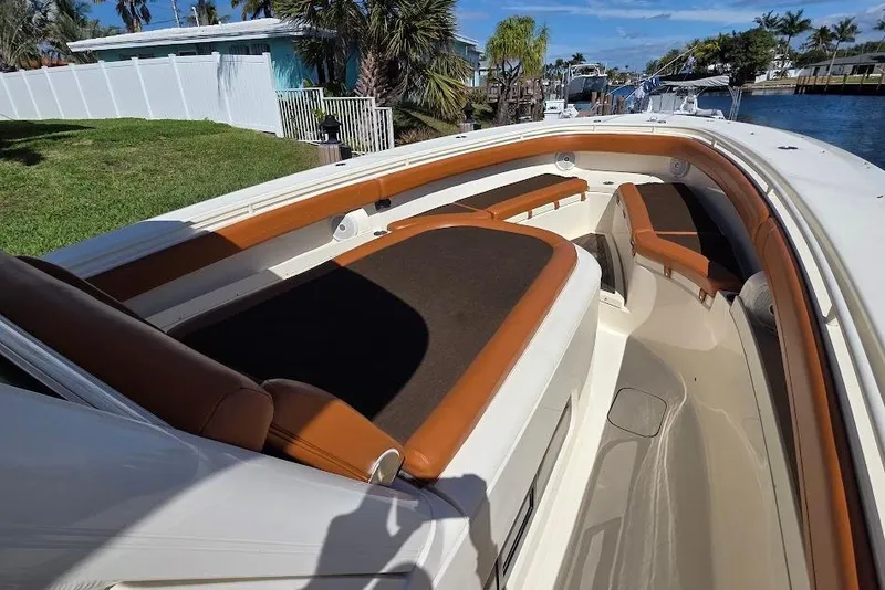 Slide: The Image of 2015 Scout 350 LXF boat interior with brown seating and spacious deck. - 29