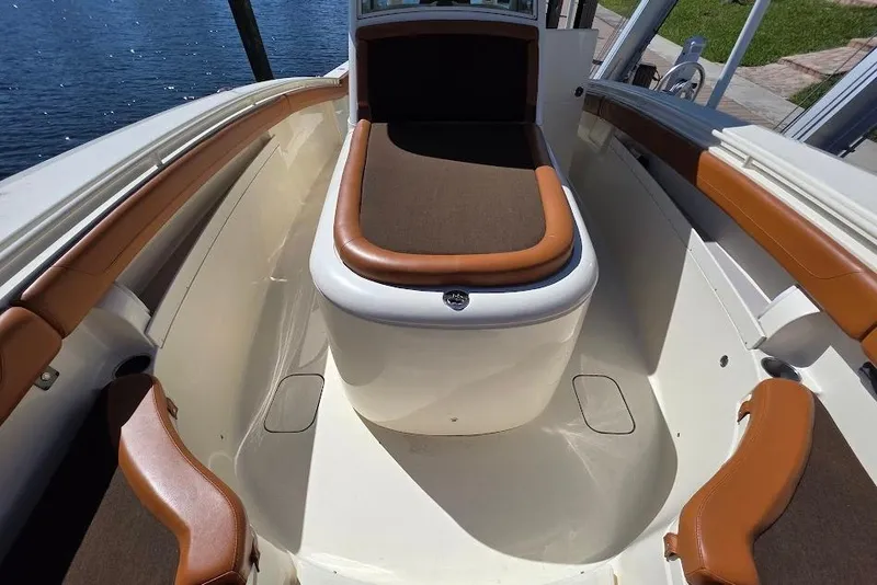 Slide: The Image of 2015 Scout 350 LXF boat interior with brown seating and white deck. - 31