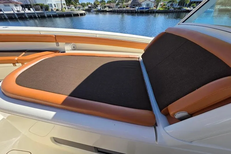 Slide: The Image of Luxurious seating on 2015 Scout 350 LXF boat, docked by waterfront homes. - 32