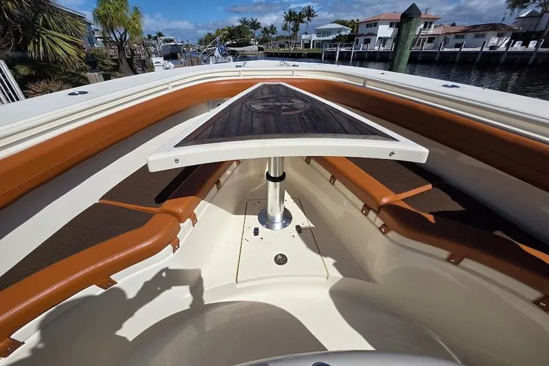 Slide: The Image of 2015 Scout 350 LXF boat interior with brown seating and a central table. - 36