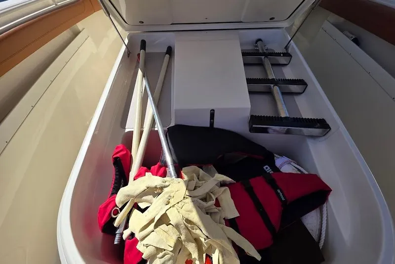 Slide: The Image of Storage compartment of a 2015 Scout 350 LXF boat with equipment and life jacket. - 39