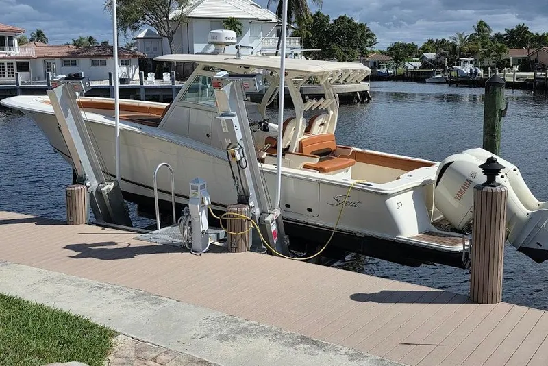 Slide: The Image of 2015 Scout 350 LXF boat docked with Yamaha engines, waterfront view. - 4