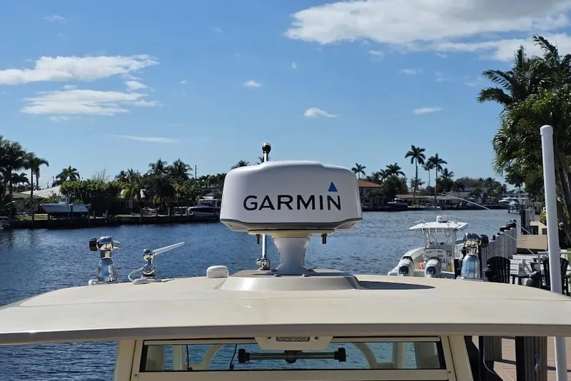 Slide: The Image of Scout 350 LXF 2015 boat with Garmin radar on a sunny waterfront. - 41