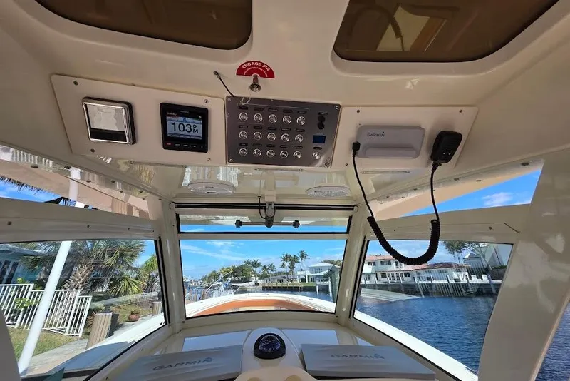Slide: The Image of Interior view of 2015 Scout 350 LXF boat cockpit with navigation controls. - 44