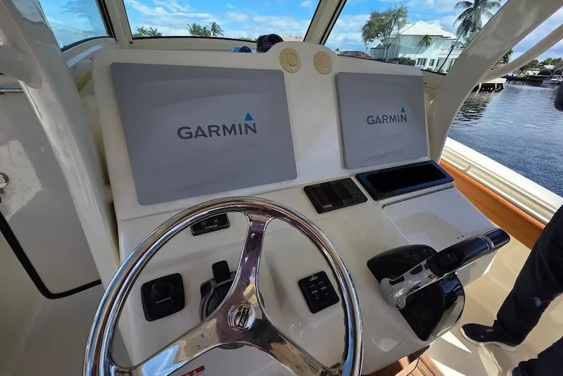 Slide: The Image of Control panel of 2015 Scout 350 LXF boat with Garmin displays and steering wheel. - 46
