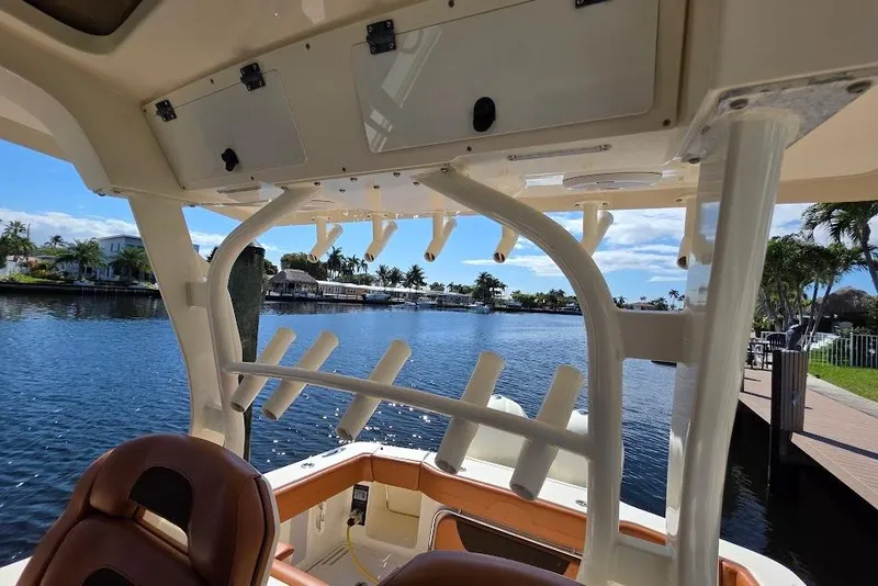 Slide: The Image of Interior view of 2015 Scout 350 LXF boat overlooking a scenic waterfront. - 51