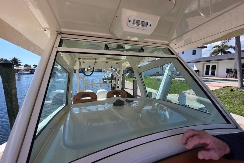 Slide: The Image of Interior view of 2015 Scout 350 LXF boat with waterfront background. - 56