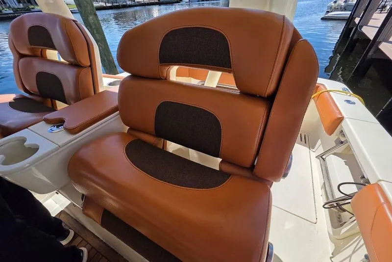 Slide: The Image of Luxurious seating on a 2015 Scout 350 LXF boat, featuring brown leather upholstery. - 63