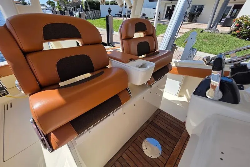 Slide: The Image of 2015 Scout 350 LXF boat interior with luxurious brown seating and wooden flooring. - 64