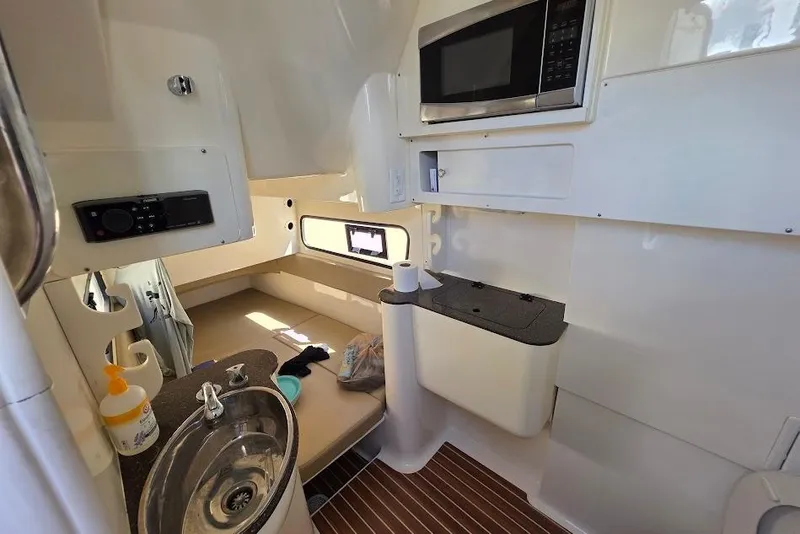 Slide: The Image of Interior of 2015 Scout 350 LXF boat with kitchenette and seating area. - 68