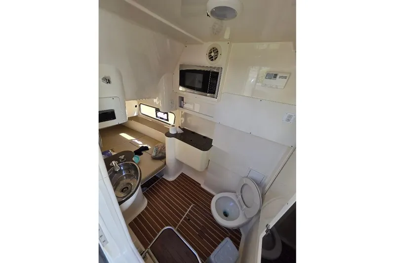 Slide: The Image of 2015 Scout 350 LXF cabin interior with sink, toilet, and microwave. - 69