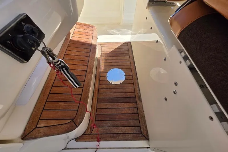 Slide: The Image of 2015 Scout 350 LXF boat interior with teak flooring and key tether. - 70