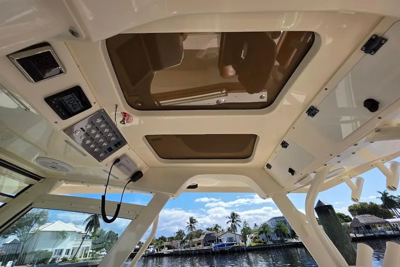 Slide: The Image of Interior view of 2015 Scout 350 LXF boat with control panel and sunroof. - 71