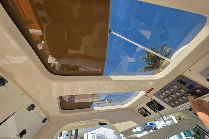 Slide: The Image of Interior view of 2015 Scout 350 LXF boat with control panel and sunroof. - 73
