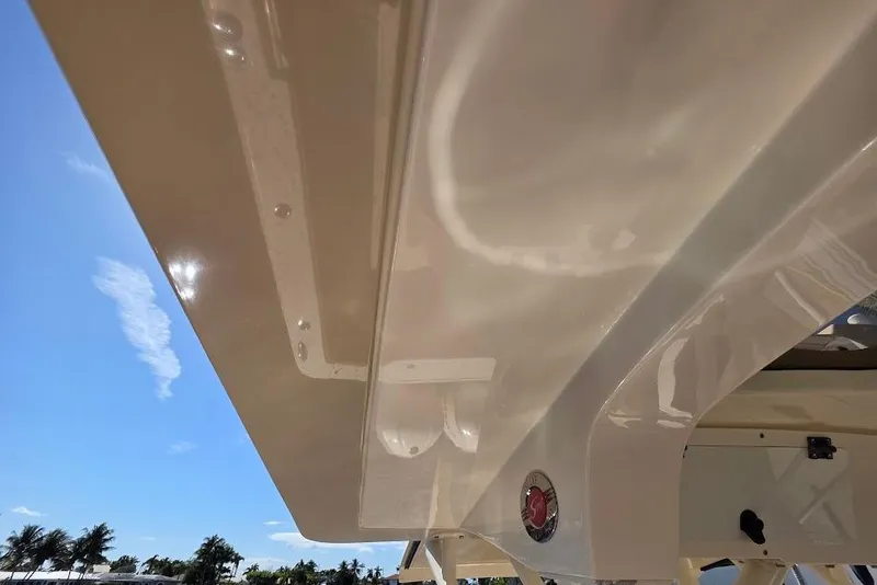 Slide: The Image of 2015 Scout 350 LXF boat detail with clear sky and palm trees. - 74