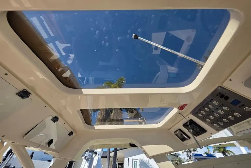 Slide: The Image of Interior view of 2015 Scout 350 LXF boat with glass roof and control panel. - 75