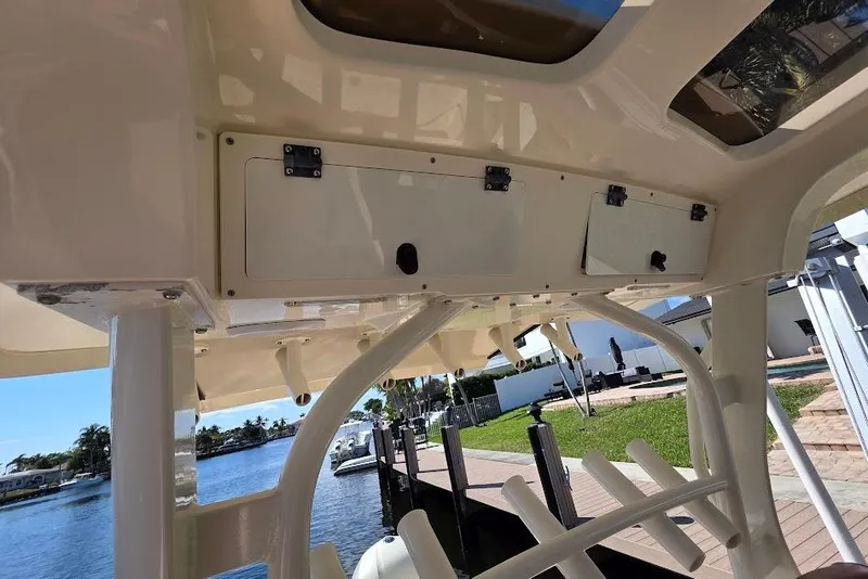 Slide: The Image of 2015 Scout 350 LXF boat interior with storage compartments and waterfront view. - 76