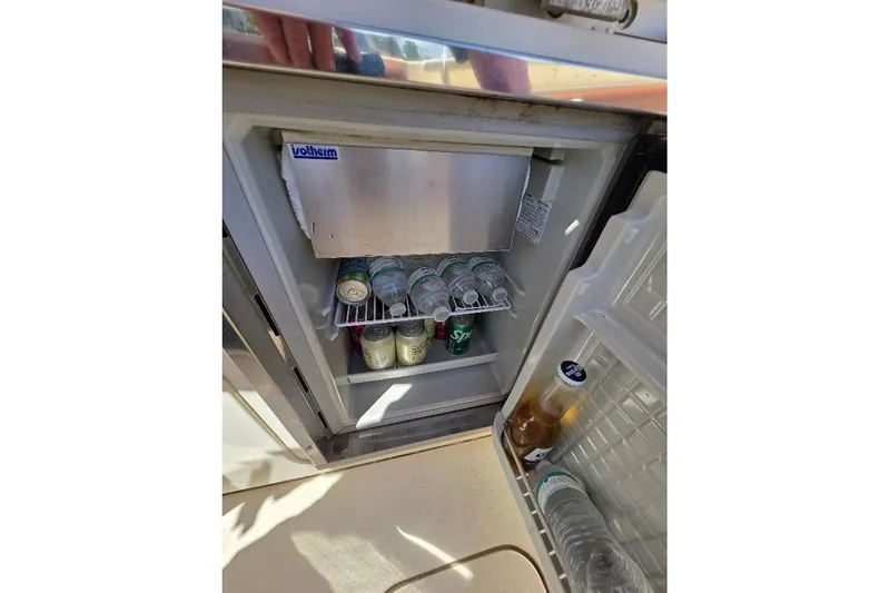 Slide: The Image of Open mini fridge on 2015 Scout 350 LXF boat, stocked with drinks. - 77