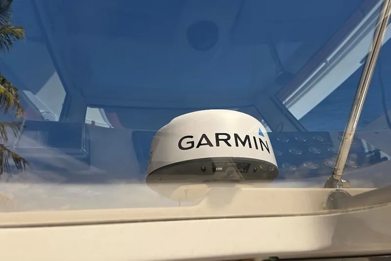 Slide: The Image of Garmin device on 2015 Scout 350 LXF boat dashboard, reflecting clear blue sky. - 78