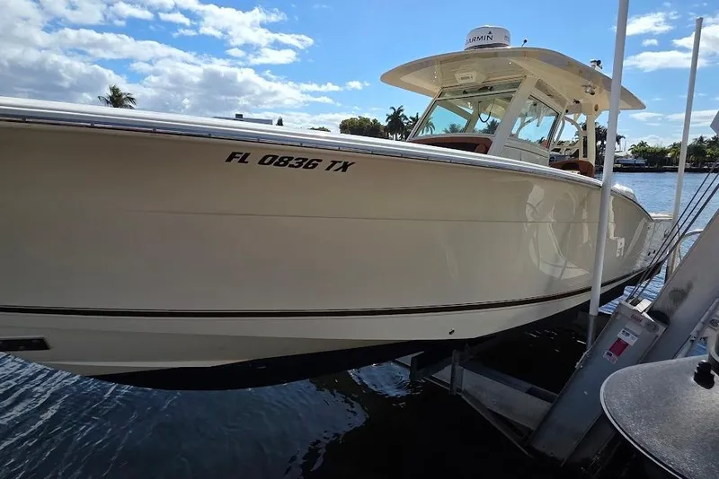 Slide: The Image of 2015 Scout 350 LXF boat docked, featuring sleek design and modern equipment. - 9