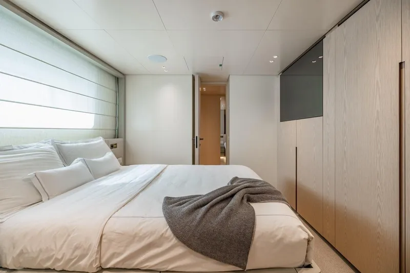 Slide: The Image of Luxurious bedroom interior on 2022 Sanlorenzo SD96 yacht, featuring modern design and cozy bedding. - 28