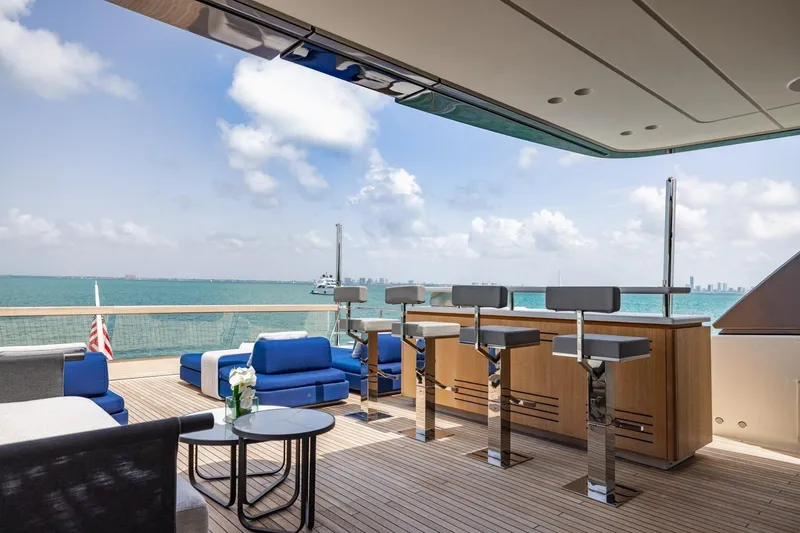Slide: The Image of Luxurious 2022 Sanlorenzo SD96 yacht deck with bar, seating, and ocean view. - 37