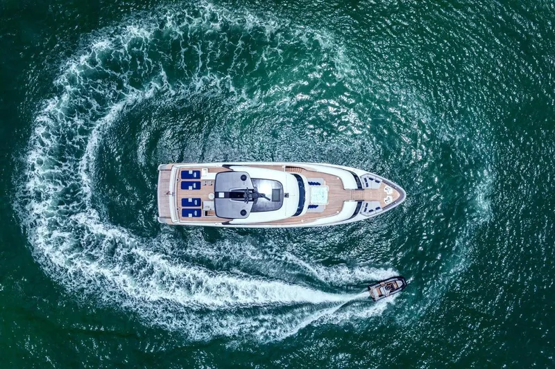 Slide: The Image of Aerial view of 2022 Sanlorenzo SD96 yacht with surrounding waves and a small boat. - 5