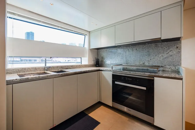 Slide: The Image of Modern kitchen in 2022 Sanlorenzo SD96 yacht with sleek cabinetry and granite countertops. - 50