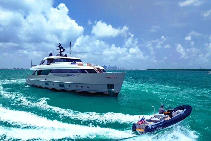 Slide: The Image of 2022 Sanlorenzo SD96 yacht cruising with a small boat in turquoise waters. - 56
