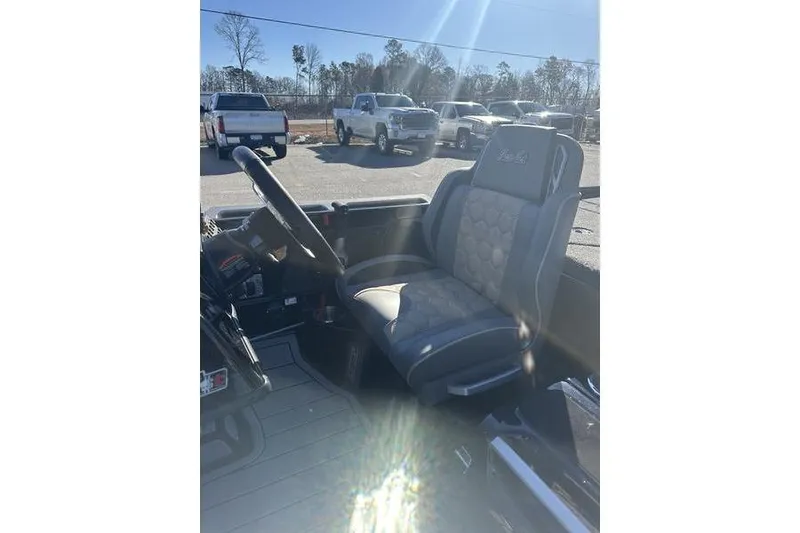 Slide: The Image of 2026 Bass Cat Puma STS interior with steering wheel and seat in sunlight. - 11