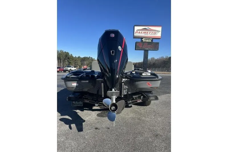 Slide: The Image of 2026 Bass Cat Puma STS boat with powerful outboard motor, parked outdoors. - 4