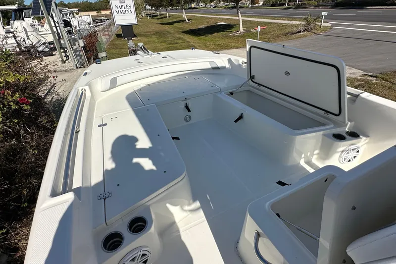 Slide: The Image of 2015 Carolina Cat 23CC boat interior at Naples Marina, featuring open storage compartments. - 10