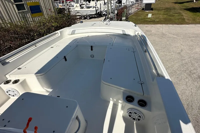 Slide: The Image of 2015 Carolina Cat 23CC boat interior with storage compartments and speakers. - 13
