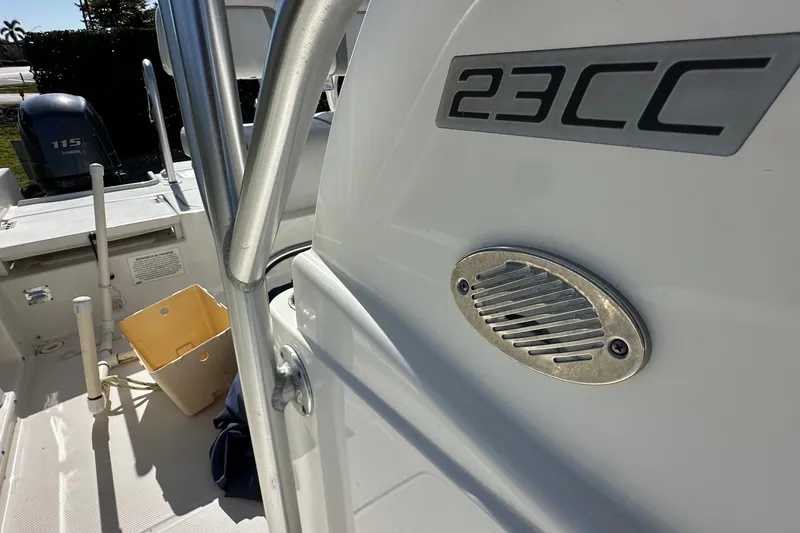 Slide: The Image of 2015 Carolina Cat 23CC boat interior with engine and storage details. - 14
