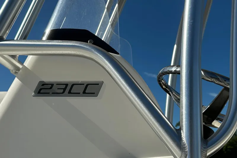 Slide: The Image of 2015 Carolina Cat 23CC boat detail with metal railing against blue sky. - 18