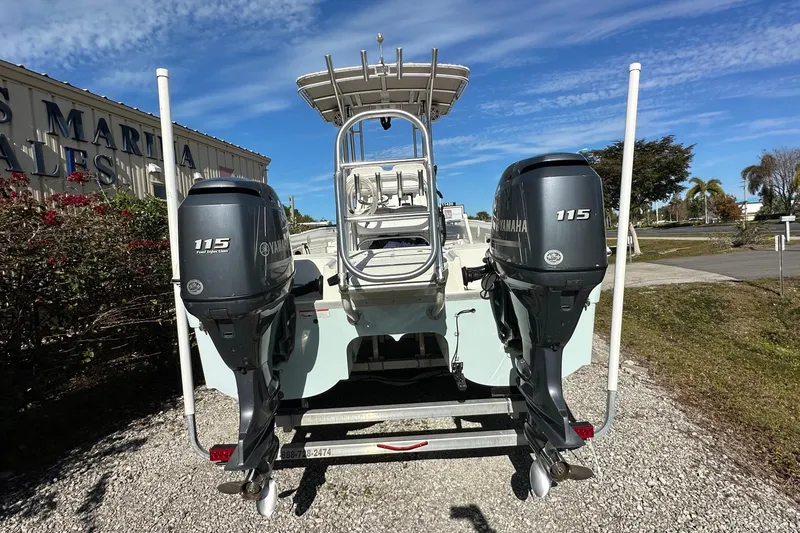 Slide: The Image of 2015 Carolina Cat 23CC boat with dual Yamaha 115 engines, parked outdoors. - 3