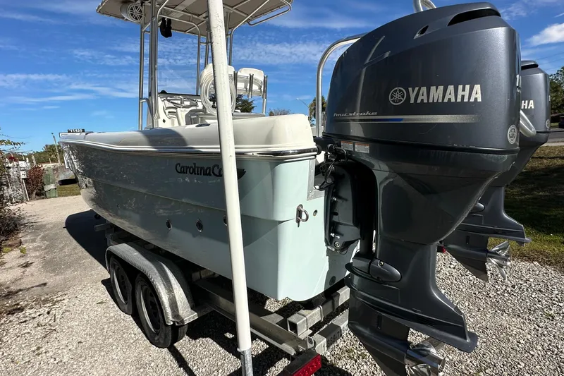 Slide: The Image of 2015 Carolina Cat 23CC boat with Yamaha outboard engines on a trailer. - 4