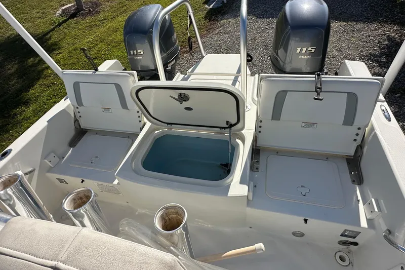 Slide: The Image of 2015 Carolina Cat 23CC boat with Yamaha 115 engines, open storage compartments. - 7