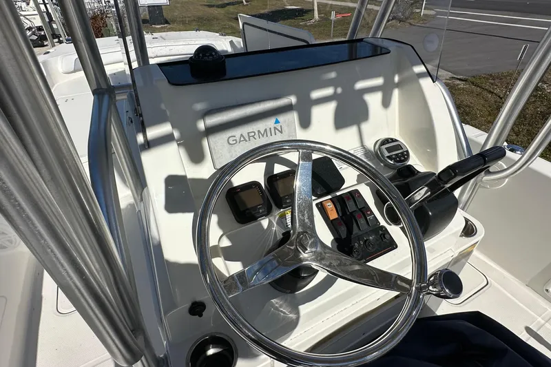 Slide: The Image of 2015 Carolina Cat 23CC boat helm with Garmin navigation system and steering wheel. - 9