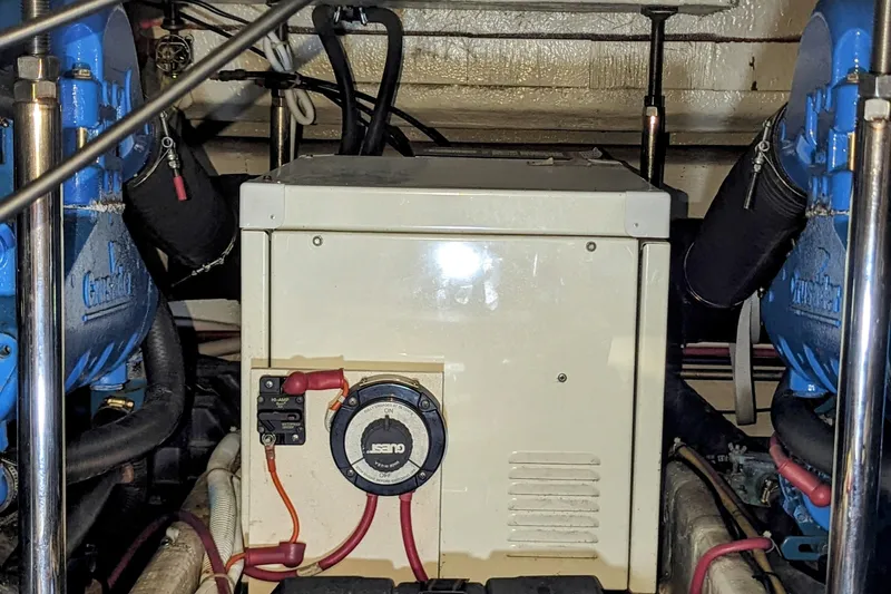 Slide: The Image of Engine room of a 2004 Carver 360 Mariner, featuring mechanical components and wiring. - 12