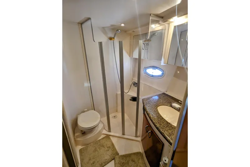 Slide: The Image of 2004 Carver 360 Mariner bathroom with shower, toilet, and granite countertop. - 13