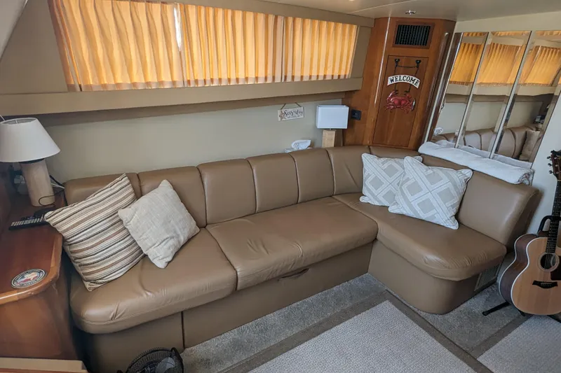 Slide: The Image of Interior of 2004 Carver 360 Mariner with leather sofa, pillows, and guitar. - 21
