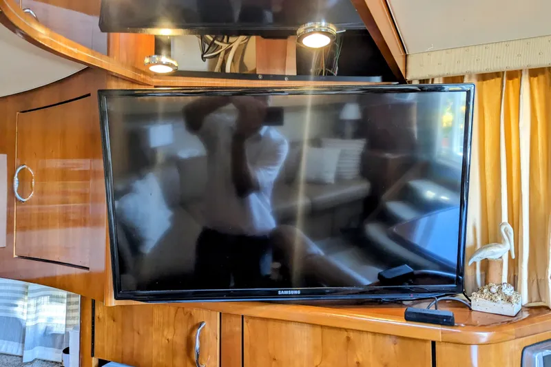 Slide: The Image of 2004 Carver 360 Mariner interior with Samsung TV and wooden cabinetry. - 23