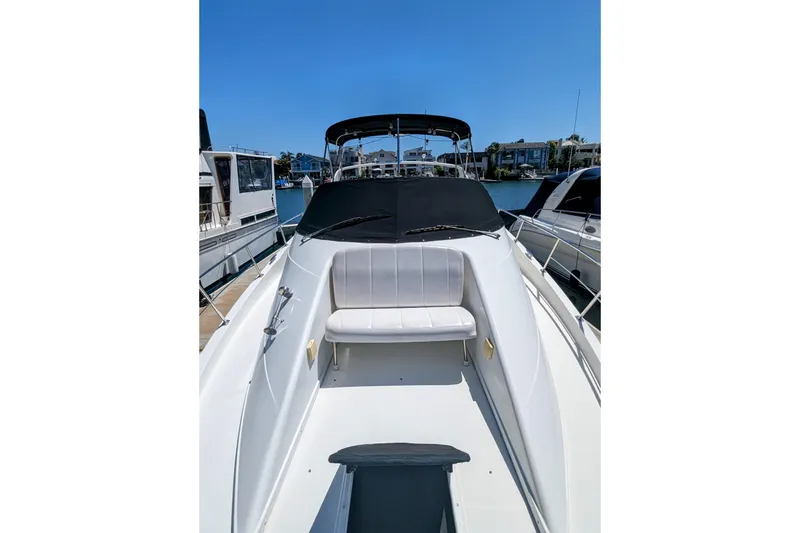 Slide: The Image of 2004 Carver 360 Mariner yacht with white seating, docked under clear blue sky. - 27